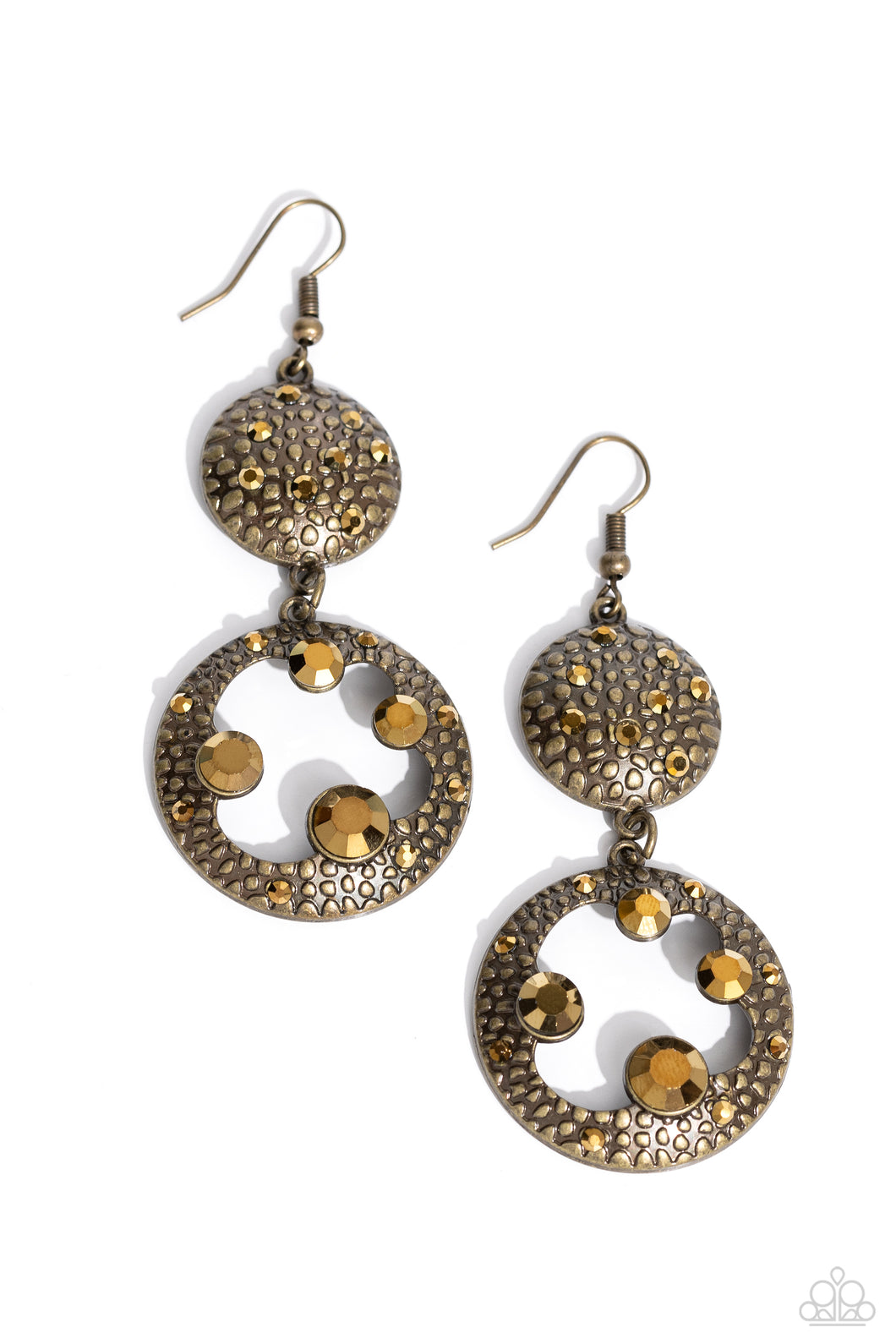 Dotted with dainty aurum rhinestones and embossed in pebble-like textures, a beveled brass circle attaches to an imperfect brass hoop featuring matching texture. A smattering of oversized aurum rhinestones haphazardly adorns the hoop, resulting in a gritty shimmer. Earring attaches to a standard fishhook fitting. 