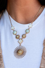 Load image into Gallery viewer, Featuring various gold fittings, white shells tilted on a point, muted blue stones, and gold sunburst frames with multicolored stone centers link below the collar on a dainty gold chain. A larger gold sunburst frame with a multicolored stone center, swings from the bottom, creating an earthy display. Features an adjustable clasp closure. As the stone elements in this piece are natural, some color variation is normal.  Sold as one individual necklace. Includes one pair of ma
