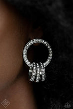 Load image into Gallery viewer, A commanding collection of silver hoops, adorned in glitzy white rhinestones, coalesces into an interlocking hoop display, creating a brilliantly stacked lure. The larger hoop the three smaller hoops adorn is also framed in glitzy white rhinestones, emitting glitz and glam from every curve. Earring attaches to a standard post fitting.  Sold as one pair of post earrings.
