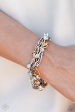 Load image into Gallery viewer, Mismatched strands of glistening gold and silver oval links are intertwined with a row of sparkling, square-cut, white rhinestones encased in sleek silver fittings, resulting in a twisted collision of grit and glamour around the wrist. Features an adjustable clasp closure.  Sold as one individual bracelet.
