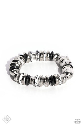 Featuring a black-dotted pattern, abstract white stone discs, black acrylic discs, and various silver discs and accents are threaded along an elastic stretchy band for a high-end, artisanal-inspired look. As the stone elements in this piece are natural, some color variation is normal.