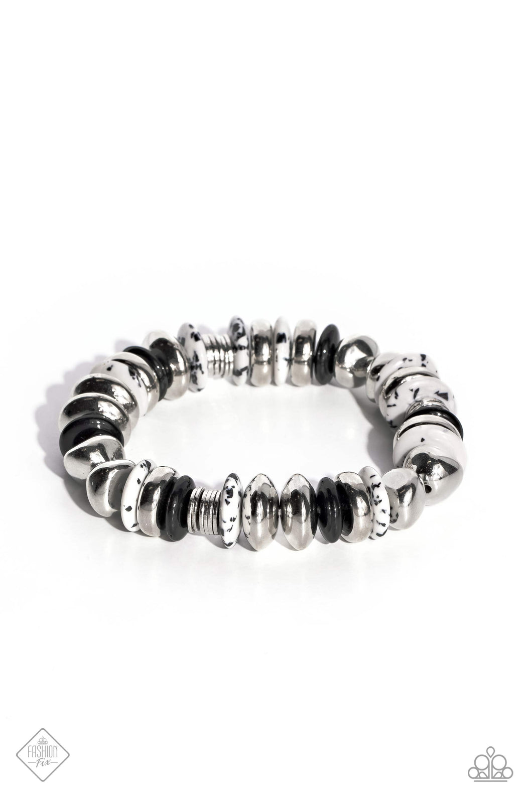 Featuring a black-dotted pattern, abstract white stone discs, black acrylic discs, and various silver discs and accents are threaded along an elastic stretchy band for a high-end, artisanal-inspired look. As the stone elements in this piece are natural, some color variation is normal.