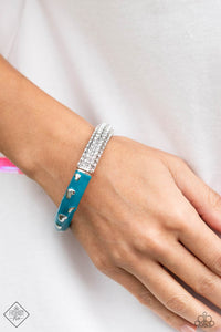 Four dainty rows of white rhinestones are encrusted across one side of a silver cuff-like bangle for a timeless fashion. Featuring a silver heart motif, the other side of the silver cuff is painted in a vibrant shade of turquoise for a carefree finish. Features a hinged closure.