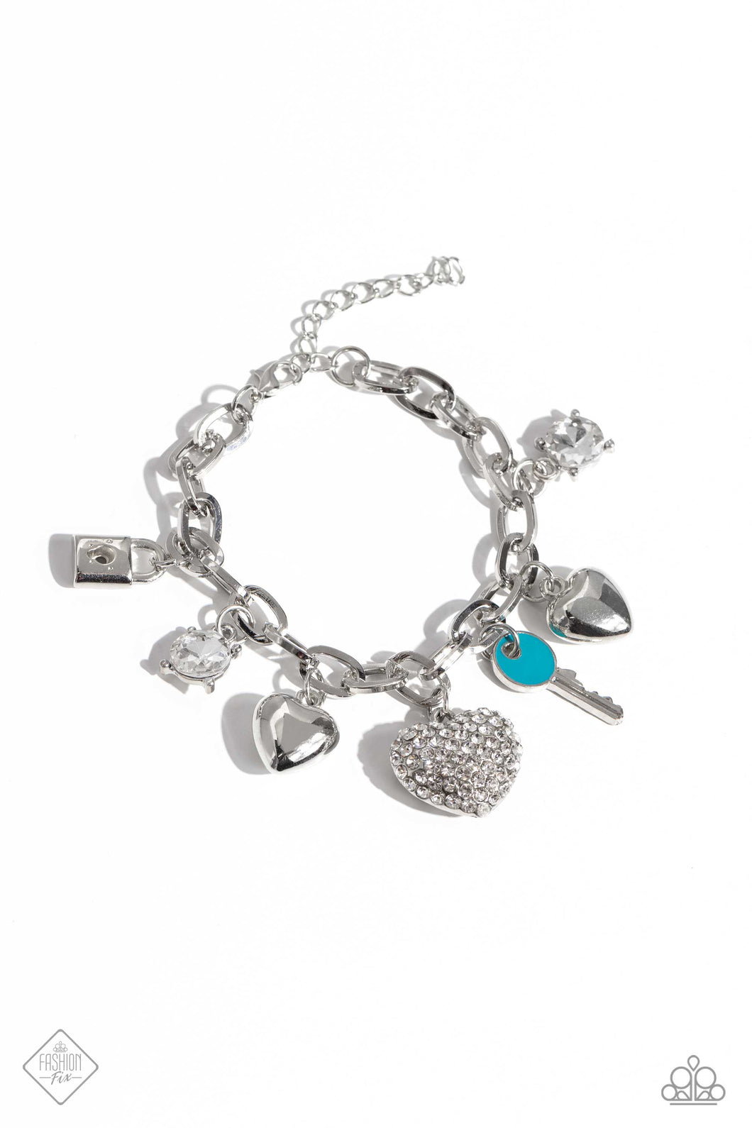 An assortment of charms, including silver hearts, pronged white gems, a turquoise-painted key and silver lock, and rhinestone-embellished thick heart dangle from a silver paperclip chain for a carefree finish around the wrist. Features an adjustable clasp closure.