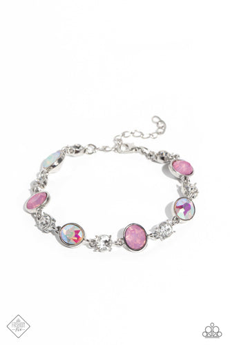 Featuring pronged silver fittings, white solitaire rhinestones alternate with oval opalescent pink and iridescent gems, linking around the wrist for a timeless, dreamy finish. Features an adjustable clasp closure. Due to its prismatic palette, color may vary.  Sold as on