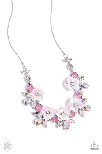 Pieces of shimmery, iridescent sequins fan out around sparkling white rhinestones to create three-dimensional flowers that bloom along the neckline. White marquise-cut gems and iridescent teardrops flare out behind each floral frame, adding irresistible sparkle to the design. Finally, pink oval rhinesto