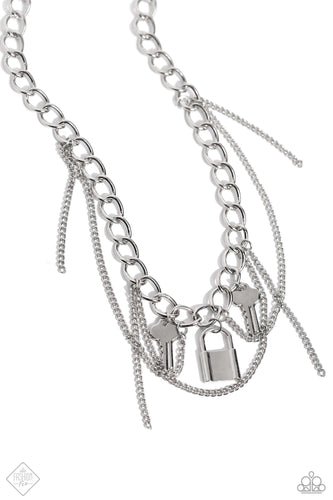 Mismatched silver chains layer down the chest. Featuring a high-metallic sheen, two key charms and a silver lock charm dangle from the upper-most chain while solitaire strands of silver chain sporadically swing and loop through the display, infusing the design with grungy movement. Features an adjustable clasp closure.  Sold as one individual necklace. Includes one pair of matching earrings.