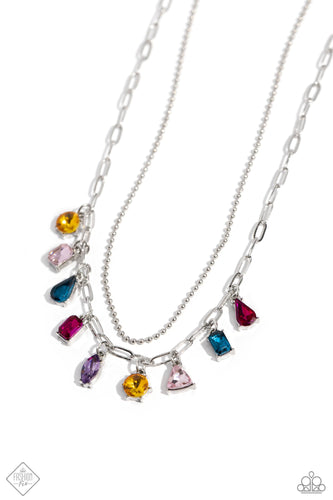 A strand of skinny silver ball chain is layered with a dainty silver paperclip chain, creating a delicate collision of refinement and grit as they lay along the collar. Set in pronged silver fittings, a multicolored gem collection in round, emerald-cut, teardrop, triangle, and marquise cuts dances from the paperclip chain for a flashy, faceted finish. Features an adjustable clasp closure.  Sold as one individual necklace. Includes one pair of matching earrings.