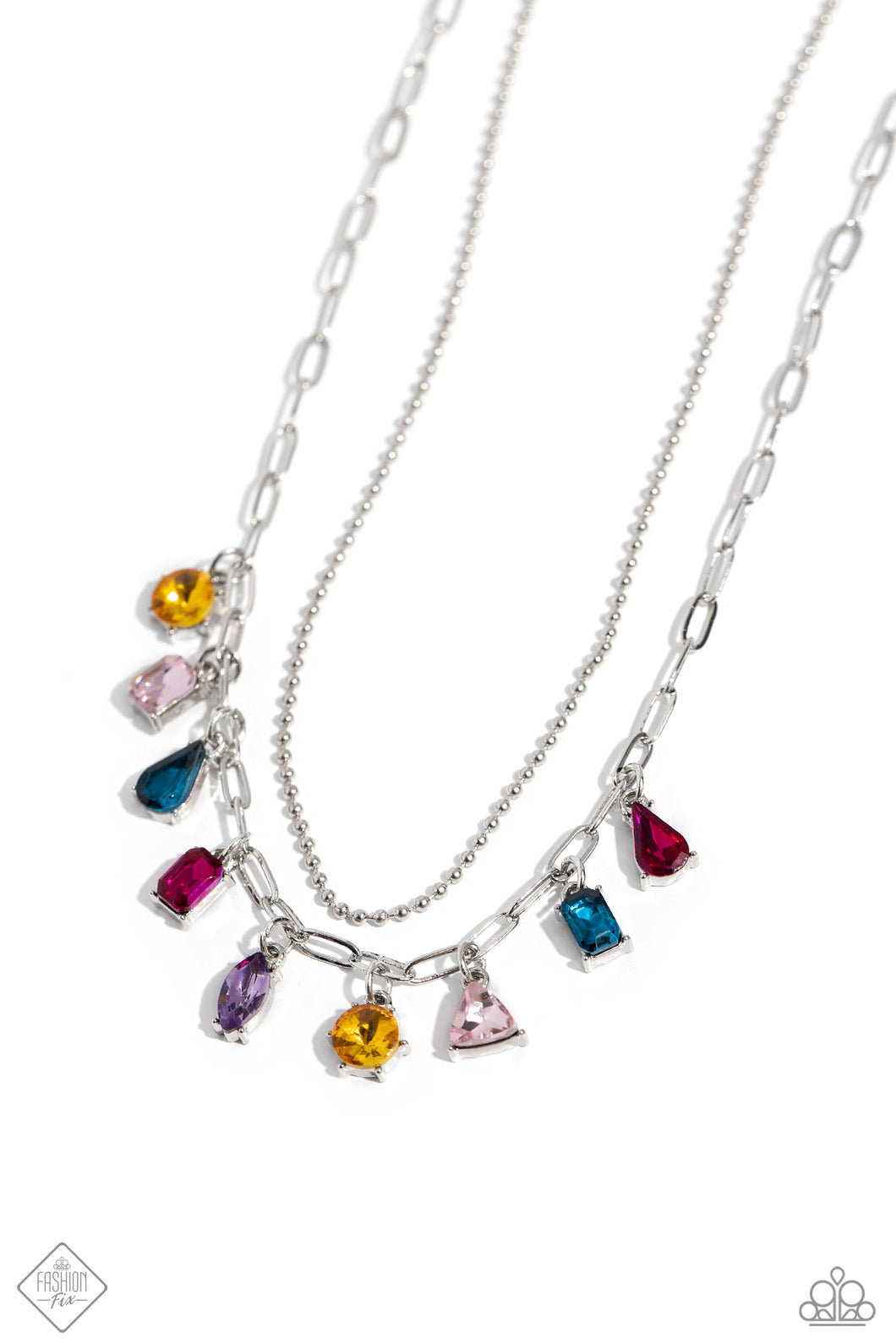 A strand of skinny silver ball chain is layered with a dainty silver paperclip chain, creating a delicate collision of refinement and grit as they lay along the collar. Set in pronged silver fittings, a multicolored gem collection in round, emerald-cut, teardrop, triangle, and marquise cuts dances from the paperclip chain for a flashy, faceted finish. Features an adjustable clasp closure.  Sold as one individual necklace. Includes one pair of matching earrings.