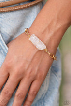 Load image into Gallery viewer, Delicately attached to a gold wire, a chiseled piece of clear white stone twists along a gold paperclip chain around the wrist, creating a decadently earthy centerpiece. Features an adjustable clasp closure.  Sold as one individual bracelet.
