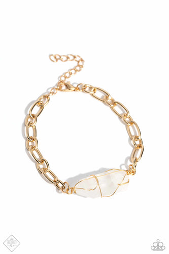 Delicately attached to a gold wire, a chiseled piece of clear white stone twists along a gold paperclip chain around the wrist, creating a decadently earthy centerpiece. Features an adjustable clasp closure.  Sold as one individual bracelet.