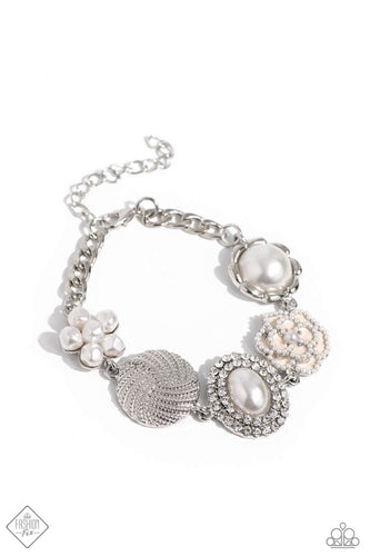 A refined display of shimmery pearl charms and floral-inspired accents gather along the wrist creating a cultivated display. The hodgepodge of texture and sheen includes pearl-adorned flowers in various shapes, borders of white rhinestones around an oval pearl center, and tactile silver studs emanating in a twisted pattern. Features an adjustable clasp closure.  Sold as one individual bracelet.  New Kit Fashion Fix