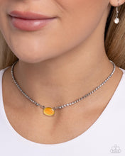 Load image into Gallery viewer, Featuring a defaced finish, a yellow cat&#39;s eye bead is pressed in a silver-pronged fitting that cascades from a glistening white rhinestone chain for a delicate, dazzling design. Features an adjustable clasp closure. 
