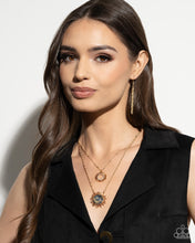 Load image into Gallery viewer, Gliding along a dainty gold chain, a gold sunburst pendant, embellished with gold foil against a navy backdrop creates a stunning sunny statement. Features an adjustable clasp closure. 
