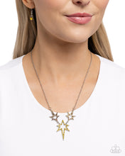 Load image into Gallery viewer, Dotted with various yellow and yellow iridescent highly reflective rhinestones, a stellar collection of silver stars of varying sizes connects and extends from a dainty silver link chain for an out-of-this-world fashion. Features an adjustable clasp closure. Due to its prismatic palette, color may vary
