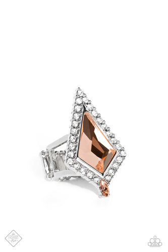 Pressed in a border of white gems and dainty silver studs, a dramatic kite-shaped peach gem stands out atop the finger. A dainty marquise-cut peach gem is pressed into the dramatic fringe, adding an additional pop of color along the fierce centerpiece. Features a stretchy band for a flexible fit.  Sold as one individual ring.  New Kit Fashion Fix