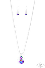 Load image into Gallery viewer, Nestled inside classic silver prongs, two oversized multi rhinestones slide along a dainty silver snake chain, creating a dramatic pendant below the collar. Features an adjustable clasp closure.  Sold as one individual necklace. Includes one pair of matching earrings.  PINK DIAMOND EXCLUSIVE
