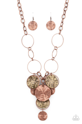 Antiqued copper hoops link with a section of chunky copper chain below the collar. An antiqued collection of copper hoops and hammered brass and copper discs cascade from the bottom of the rustic display, creating a noisy fringe. Features an adjustable clasp closure.