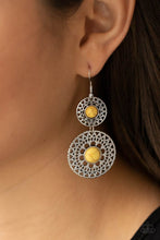 Load image into Gallery viewer, Stenciled in airy metallic sunburst patterns, a pair of silver mandala-like frames are dotted with sunny yellow stone centers as they link into a tribal inspired lure. Earring attaches to a standard fishhook fitting.
