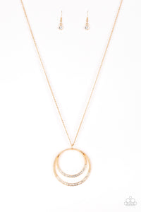 A daring circular pendant swings from the bottom of an elongated gold chain for a refined look. The bottoms of the ornate gold pendant are encrusted in white rhinestones for a glamorous finish. Features an adjustable clasp closure.