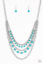 Load image into Gallery viewer, Featuring refreshing turquoise stone accents, mismatched silver chains layer below the collar for a seasonal look. Features an adjustable clasp closure.  Sold as one individual necklace. Includes one pair of matching earrings.
