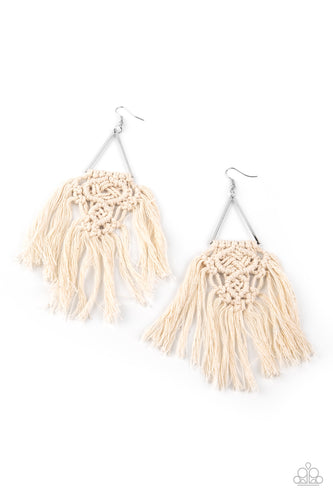 White threaded tassels ornately knot at the bottom of a shimmery silver triangular frame, creating a macramé inspired fringe. Earring attaches to a standard fishhook fitting.
