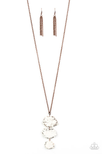As if chipped off a cliff, pieces of white rock link at the bottom of a lengthened copper chain for an earthy look. As the stone elements in this piece are natural, some color variation is normal. Features an adjustable clasp closure.  Sold as one individual necklace. Includes one pair of matching earrings.