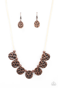 Hammered in a rustic finish, asymmetrical oval frames and antiqued copper beads alternate along a strip of white suede below the collar, creating a bold fringe. Features an adjustable clasp closure.  Sold as one individual necklace. Includes one pair of matching earrings.