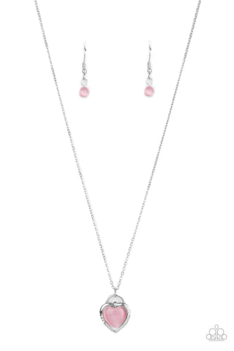 Featuring a pink cat's eye stone center, a glistening silver locket inspired frame glides along a dainty silver chain below the collar for a charming look. Sections of dainty white rhinestones dot the silver heart frame, adding flirty hints of shimmer. Features an adjustable clasp closure.