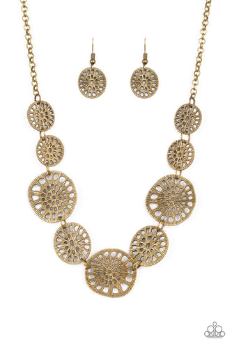 Featuring airy stenciled patterns, shimmery brass discs link below the collar for a whimsical asymmetrical look. Features an adjustable clasp closure.  Sold as one individual necklace. Includes one pair of matching earrings.