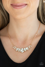 Load image into Gallery viewer, Featuring a dramatically oversized white teardrop rhinestone center, dainty white rhinestone encrusted gold frames connect with pairs of glassy marquise cut rhinestones below the collar for a sparkly statement-making look. Features an adjustable clasp closure.  Sold as one individual necklace. Includes one pair of matching earrings.
