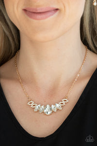 Featuring a dramatically oversized white teardrop rhinestone center, dainty white rhinestone encrusted gold frames connect with pairs of glassy marquise cut rhinestones below the collar for a sparkly statement-making look. Features an adjustable clasp closure.  Sold as one individual necklace. Includes one pair of matching earrings.