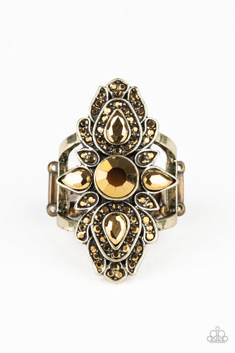 Featuring round and teardrop cuts, glittery aurum rhinestones scatter across petal-like brass frames, coalescing into a regal centerpiece atop the finger. Features a stretchy band for a flexible fit.