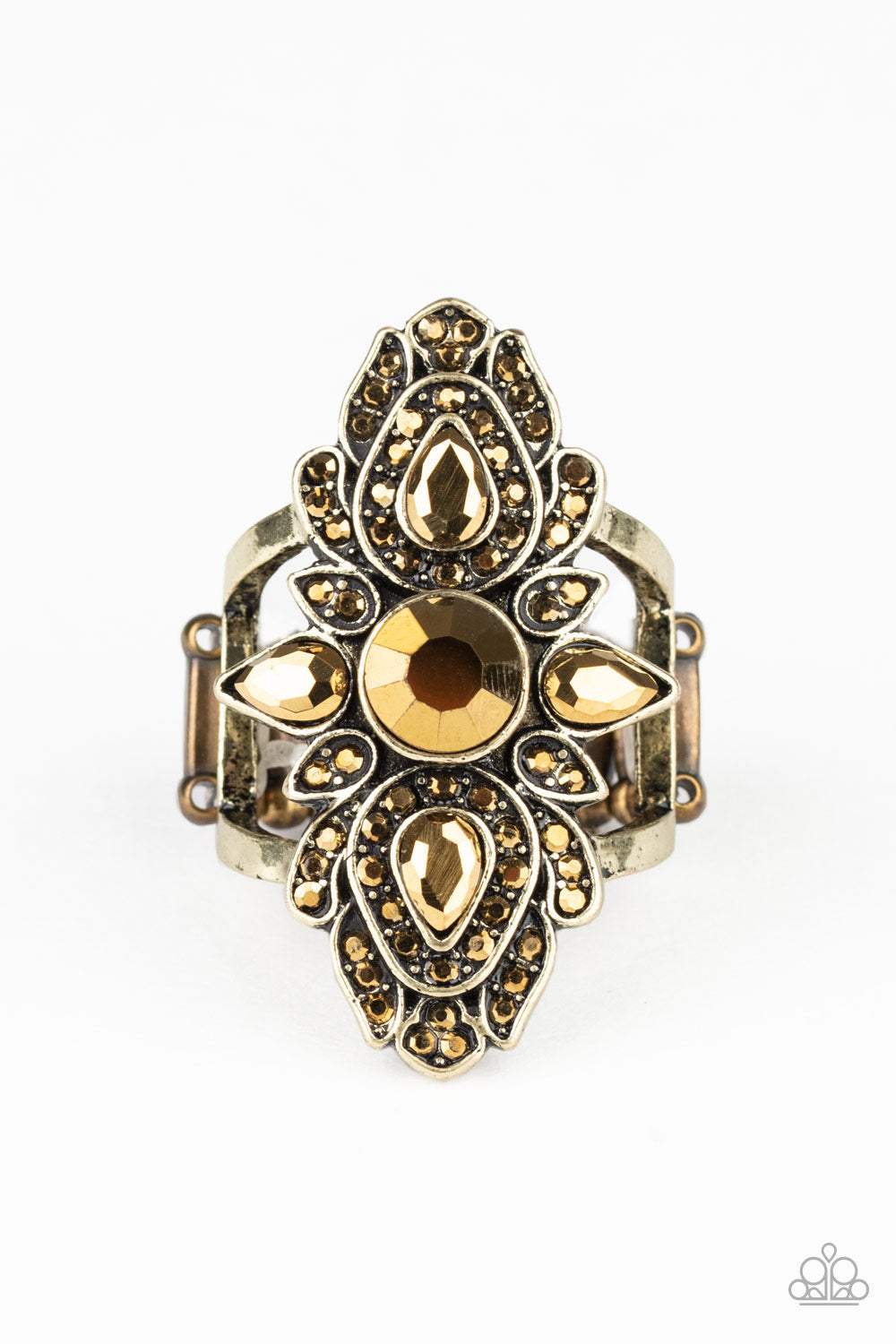 Featuring round and teardrop cuts, glittery aurum rhinestones scatter across petal-like brass frames, coalescing into a regal centerpiece atop the finger. Features a stretchy band for a flexible fit.