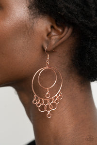 A dainty collection of shiny copper rings swing from the bottom of interconnected shiny copper hoops, creating a dizzying fringe. Earring attaches to a standard fishhook fitting.  Sold as one pair of earrings.