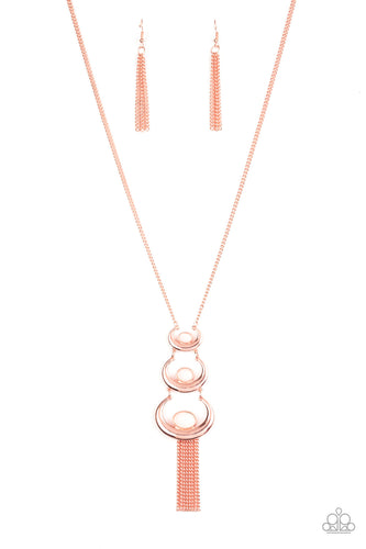 Gradually increasing in size, shiny copper moon frames curl around dewy peach beaded centers at the bottom of a classic shiny copper chain. Strands of matching shiny copper chains stream out from the bottom of the stacked pendant, creating a whimsical fringe. Features an adjustable clasp closure.  Sold as one individual necklace. Includes one pair of matching earrings.