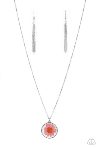 A pink daisy is encased inside a glassy casing, creating a whimsical floral pendant beneath the collar. Features an adjustable clasp closure.  Sold as one individual necklace. Includes one pair of matching earrings.
