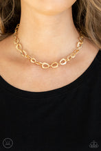 Load image into Gallery viewer, Embossed in a metallic crocodile-like print, asymmetrical gold links delicately connect around the neck for a wild industrial inspired look. Features an adjustable clasp closure.  Sold as one individual choker necklace. Includes one pair of matching earrings.  New Kit Choker
