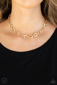 Embossed in a metallic crocodile-like print, asymmetrical gold links delicately connect around the neck for a wild industrial inspired look. Features an adjustable clasp closure.  Sold as one individual choker necklace. Includes one pair of matching earrings.  New Kit Choker