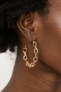 An immovable row of gold chain delicately twists into an edgy hoop for an intense industrial vibe. Earring attaches to a standard post fitting. Hoop measures approximately 1 3/4" in diameter.  Sold as one pair of hoop earrings.