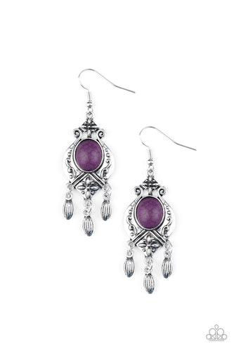A vivacious purple stone is pressed into a silver frame radiating with floral details. Dainty silver beads swing from the bottom of the frame, adding a wanderlust finish to the seasonal palette. Earring attaches to a standard fishhook fitting.