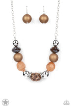 Load image into Gallery viewer, Warm beads in shades of brown and copper with reflective faceted edges and varying glazed finishes are offset by two shiny silver beads.  An oblong bead studded with copper-toned rhinestones adds a dramatic accent.  Features an adjustable clasp closure. 
