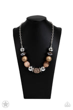 Load image into Gallery viewer, Warm beads in shades of brown and copper with reflective faceted edges and varying glazed finishes are offset by two shiny silver beads.  An oblong bead studded with copper-toned rhinestones adds a dramatic accent.  Features an adjustable clasp closure. 
