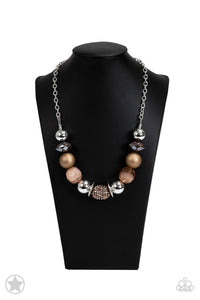 Warm beads in shades of brown and copper with reflective faceted edges and varying glazed finishes are offset by two shiny silver beads.  An oblong bead studded with copper-toned rhinestones adds a dramatic accent.  Features an adjustable clasp closure. 