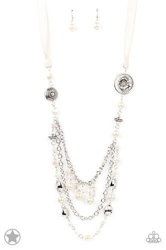 A silky ivory ribbon replaces a traditional chain to create an elegant look. Pearly ivory beads and funky silver pieces intermix with varying lengths of silver chains to give a fresh take on a Victorian-inspired piece.