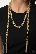 Load image into Gallery viewer, A single strand of spiraling, interlocking links with light-catching texture is anchored by two tassels of chain that add dramatic length to the piece. Undeniably the most versatile piece in Paparazzi&#39;s history, the scarf necklace features FIVE different ways to accessorize: Open Layer, Loop, Traditional Wrap, Double Knot, and Nautical Knot.
