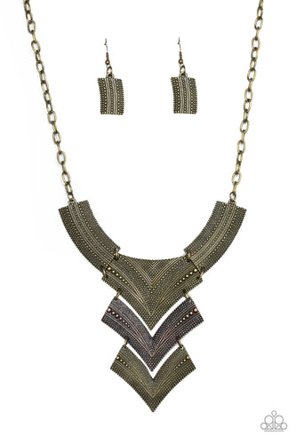 Radiating in studded details, antiqued brass and copper plates link below the collar, joining into a fierce geometric pendant. Features an adjustable clasp closure.
