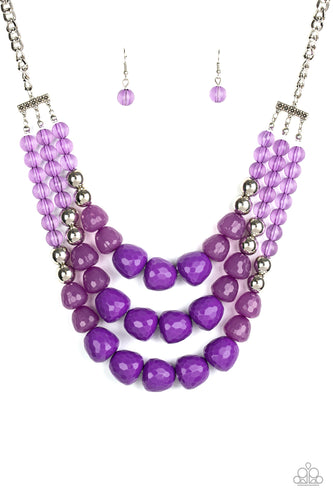 Varying in shape and opacity, a collection of round and asymmetrical purple beads are threaded along invisible wires below the collar. Shiny silver beads sprinkled along the strands, adding hints of shimmer to the fruity layers. Features an adjustable clasp closure.