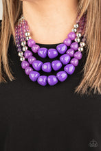 Load image into Gallery viewer, Varying in shape and opacity, a collection of round and asymmetrical purple beads are threaded along invisible wires below the collar. Shiny silver beads sprinkled along the strands, adding hints of shimmer to the fruity layers. Features an adjustable clasp closure.

