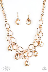 Joined by dainty gold links, two rows of dramatic gold chain layer below the collar in a fierce fashion. Golden teardrops drip from the glistening layers, adding a timeless shimmer to the show-stopping piece.  Features an adjustable clasp closure. 